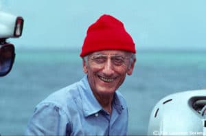 Jacques Cousteau wearing his iconic red hat, symbolizing ocean exploration and the legacy of The Cousteau Society, featured on the homepage.